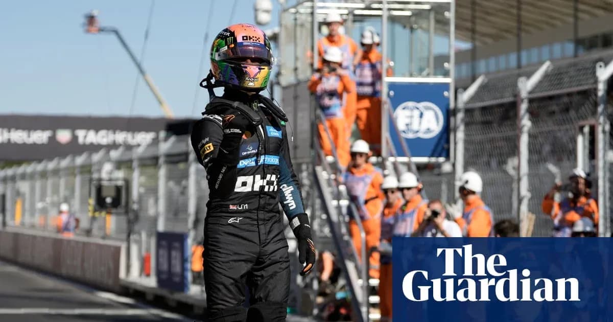 Driver celebrating after race with pit crew in background