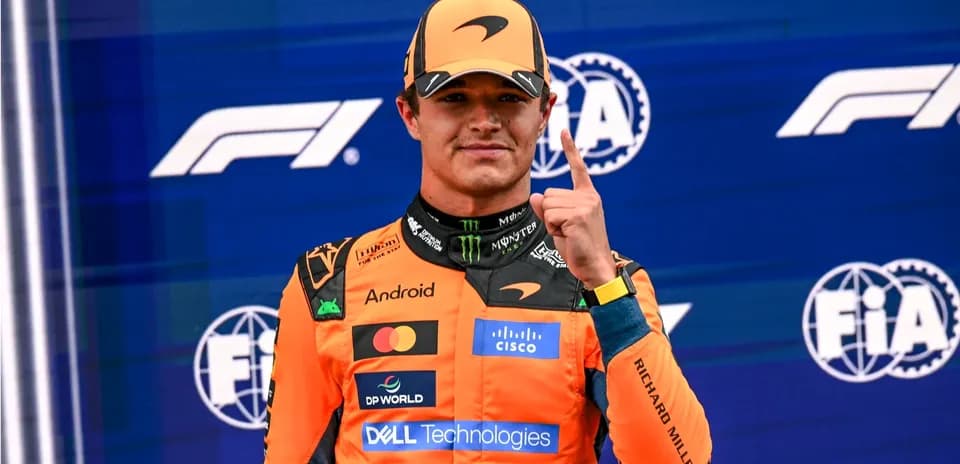 Driver celebrating with number one gesture on podium