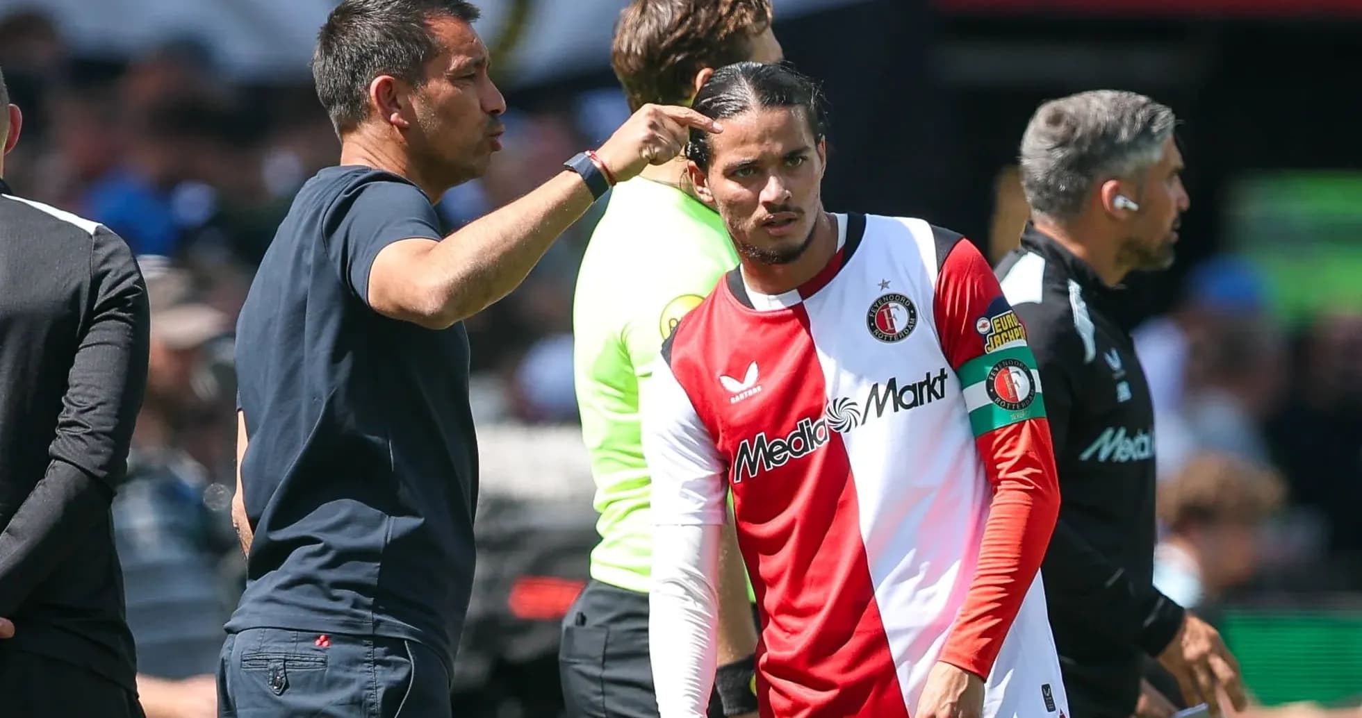 Coach giving instructions to player on the sidelines