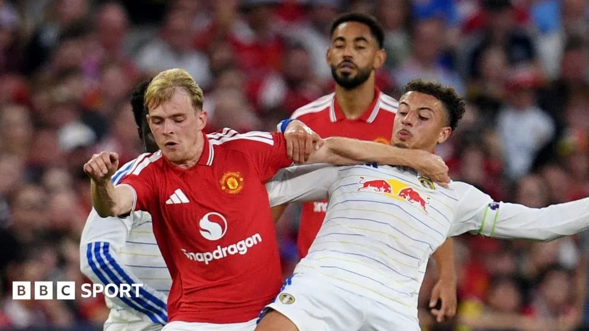 Two players grappling for the ball during match