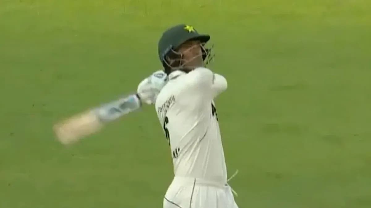 Batsman swinging bat during cricket match