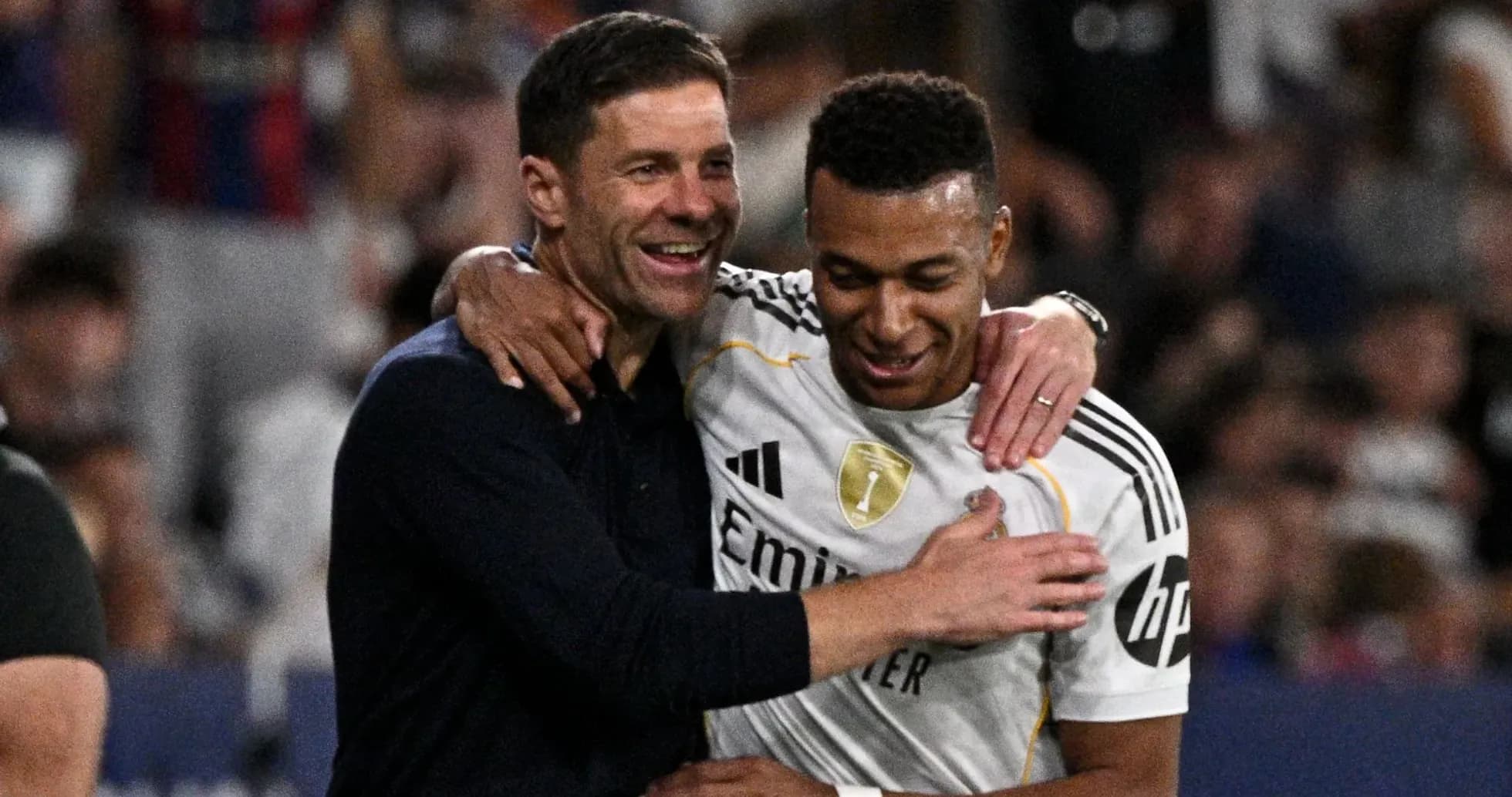 Coach and player celebrating together on the field