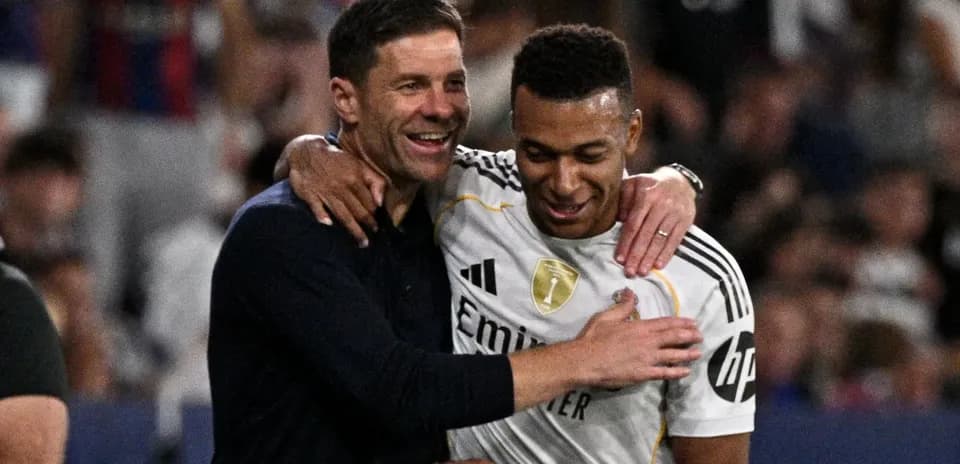 Coach and player celebrating together on the field