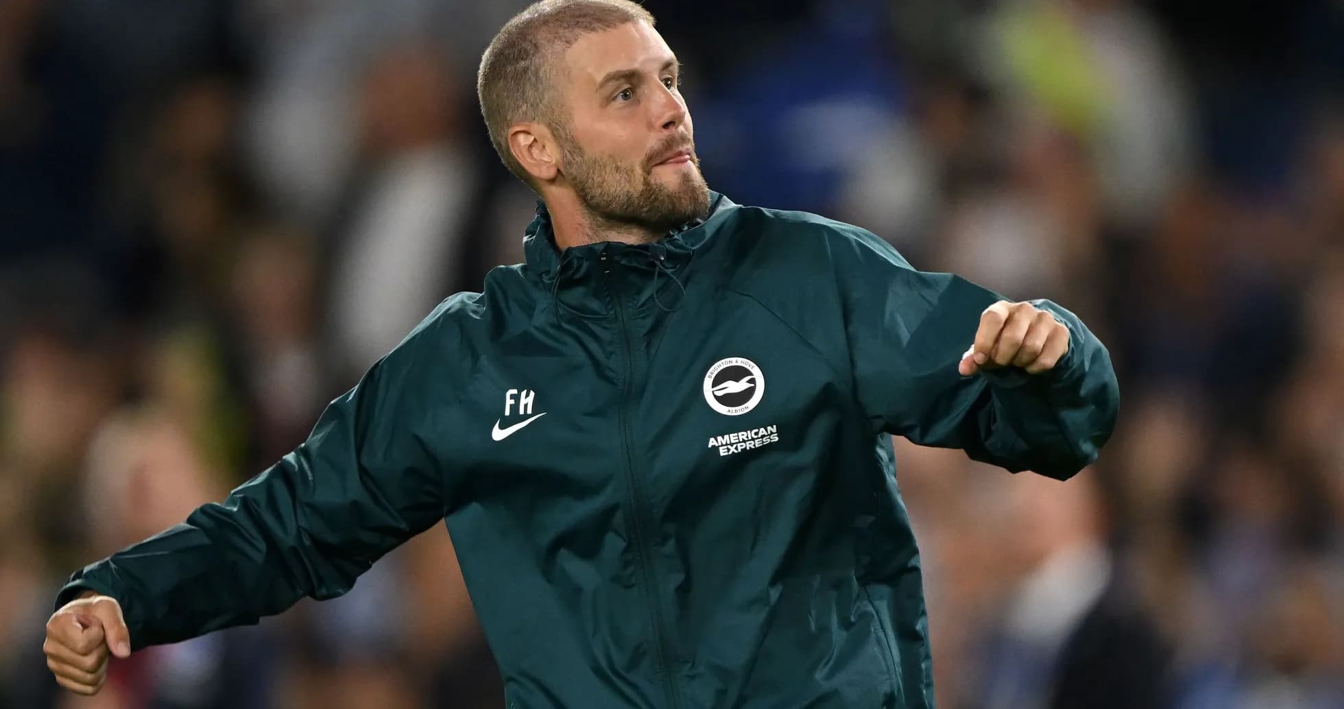 Assistant coach celebrating on the sidelines during match