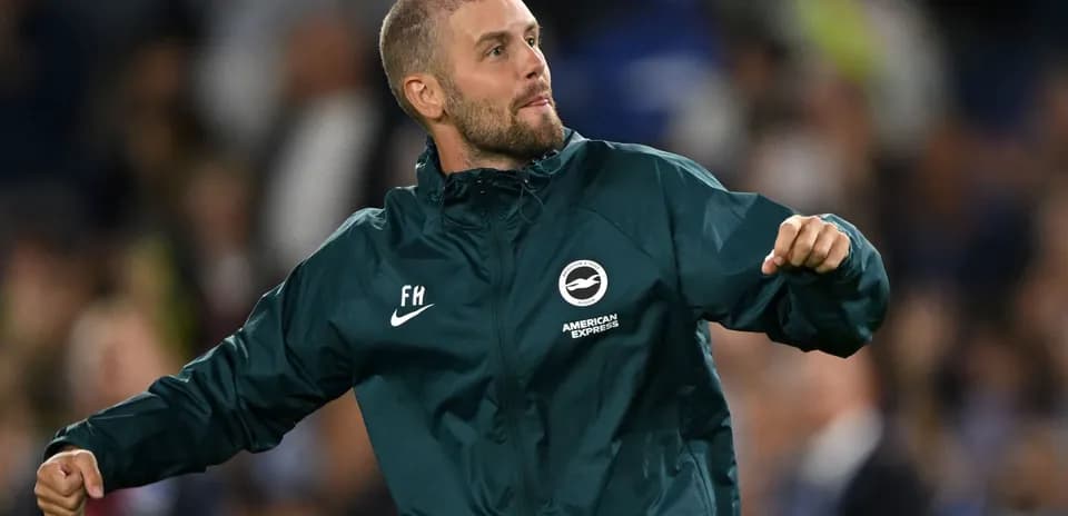 Assistant coach celebrating on the sidelines during match