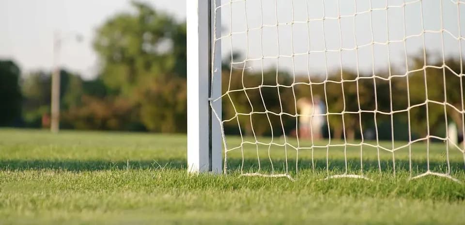 Close-up of a soccer goal net on field