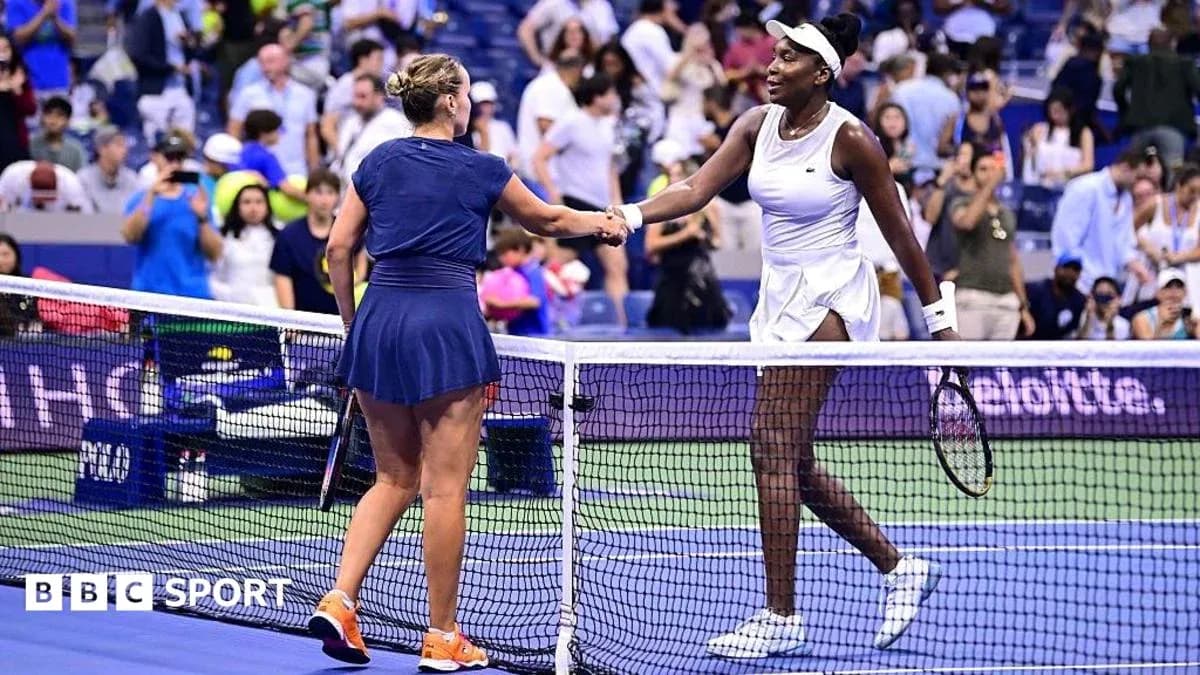 Two tennis players shaking hands at net