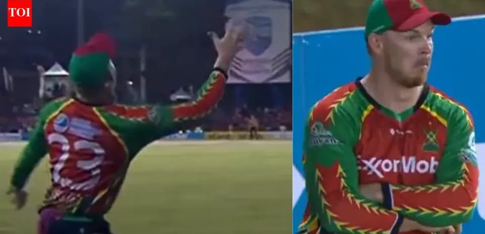Cricketer catching ball during match action