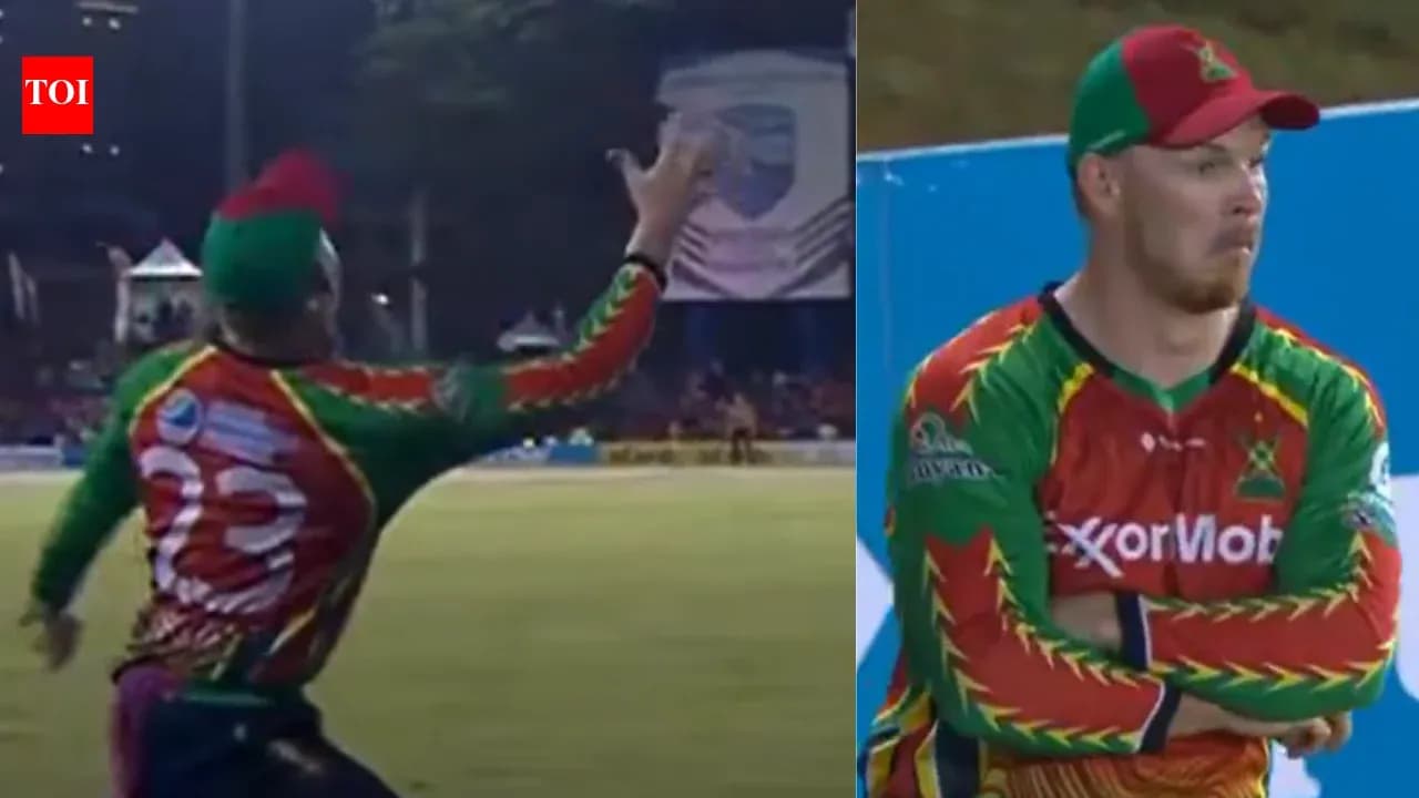 Cricketer catching ball during match action