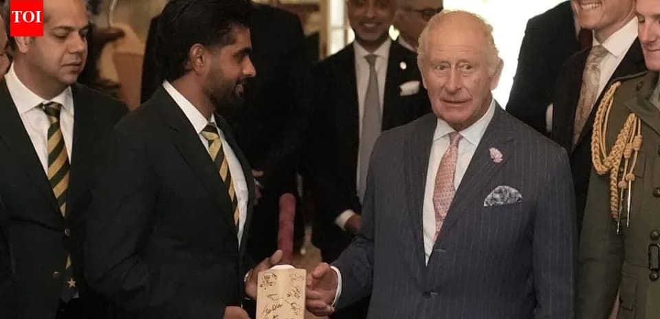 Cricket team presenting signed bat to King Charles
