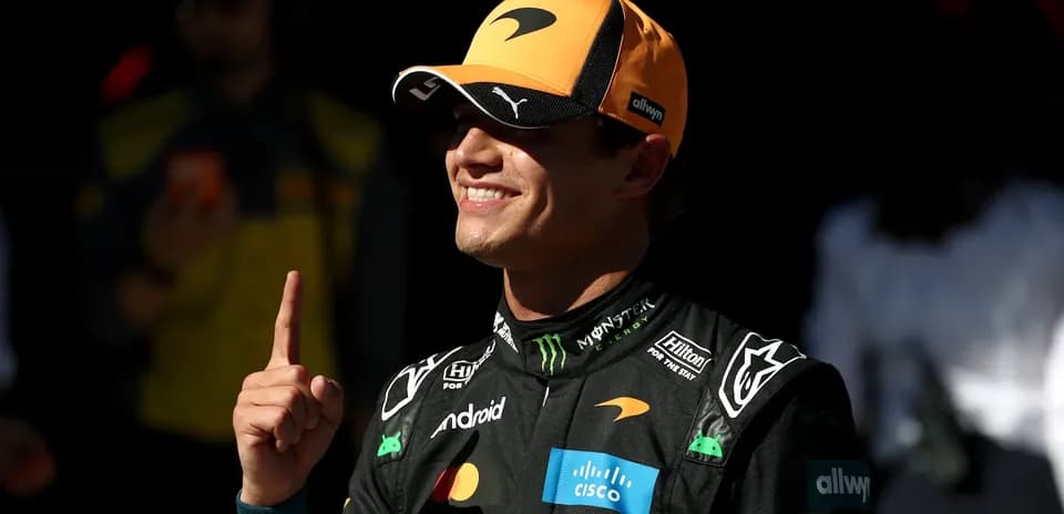 Driver celebrating with a finger raised in the air