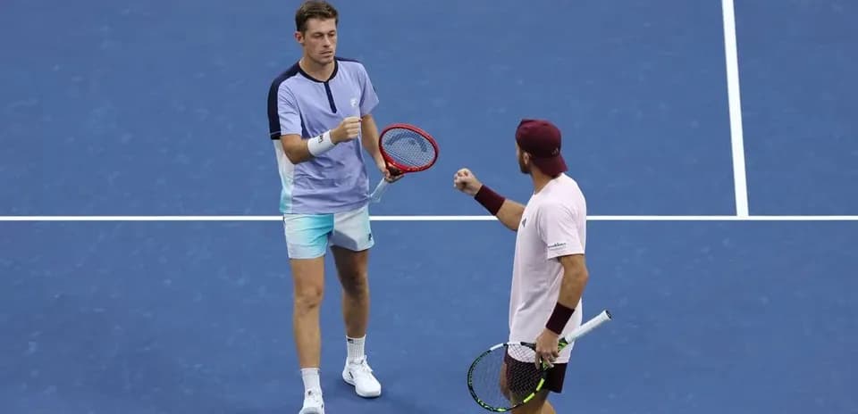 Two tennis players celebrating on court