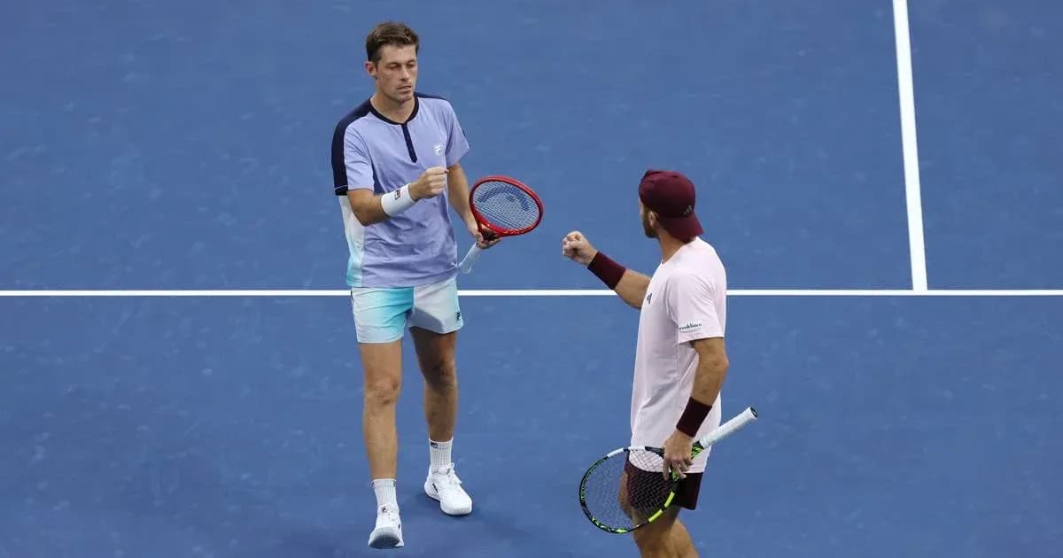 Two tennis players celebrating on court