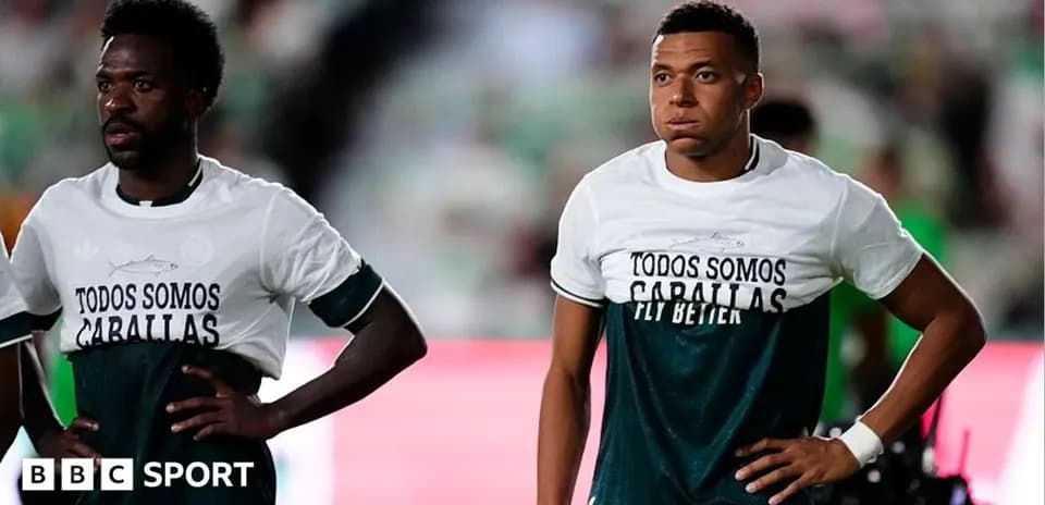 Two players wearing matching shirts before a match