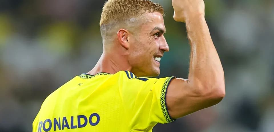 Player celebrating with raised fist in yellow jersey