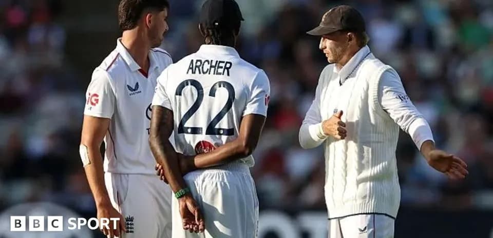 Cricket players discussing strategy on the field