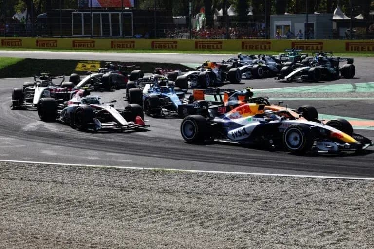 Multiple Formula 1 cars racing on track during competition