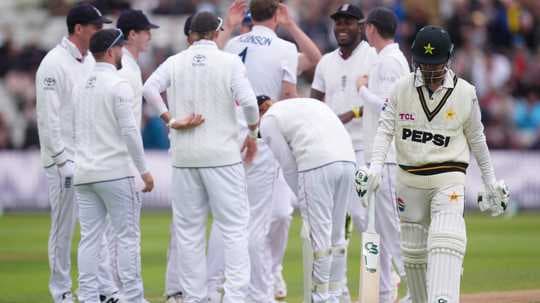 Pakistani player walking past celebrating English team