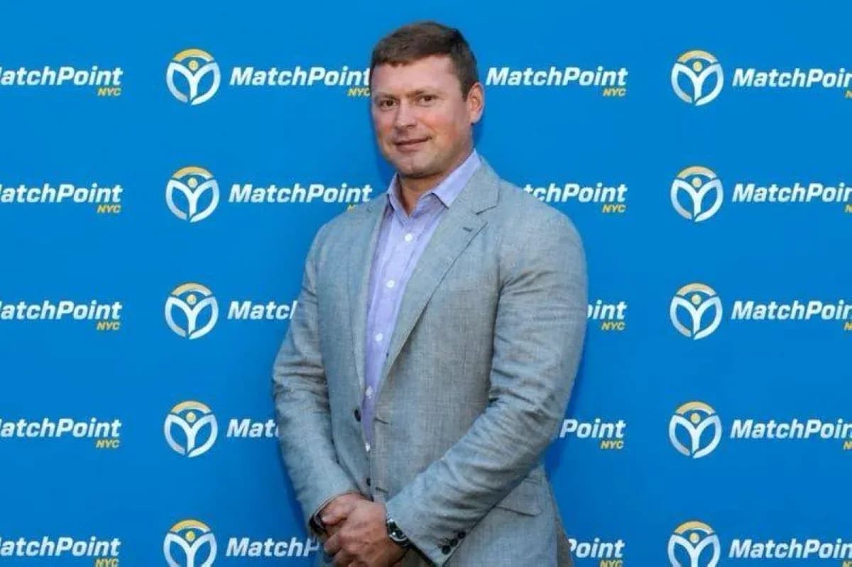 Man in suit posing against MatchPoint backdrop