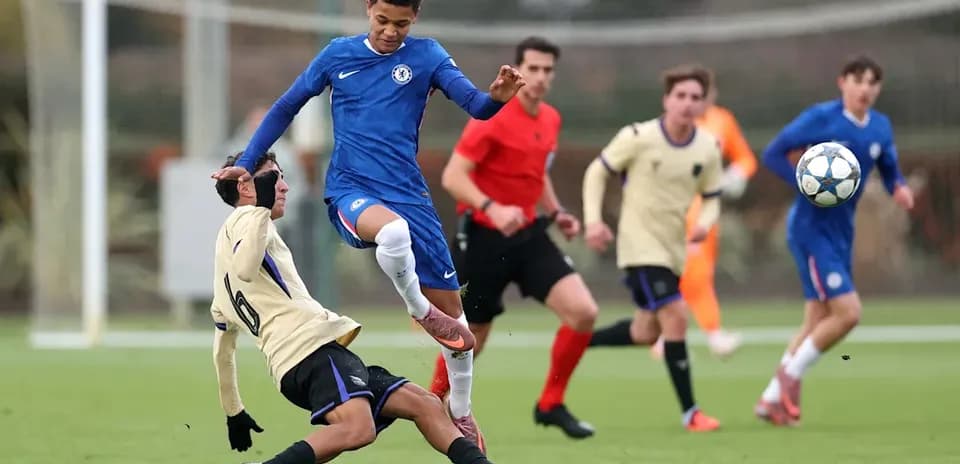 Player in blue jumping over opponent on field