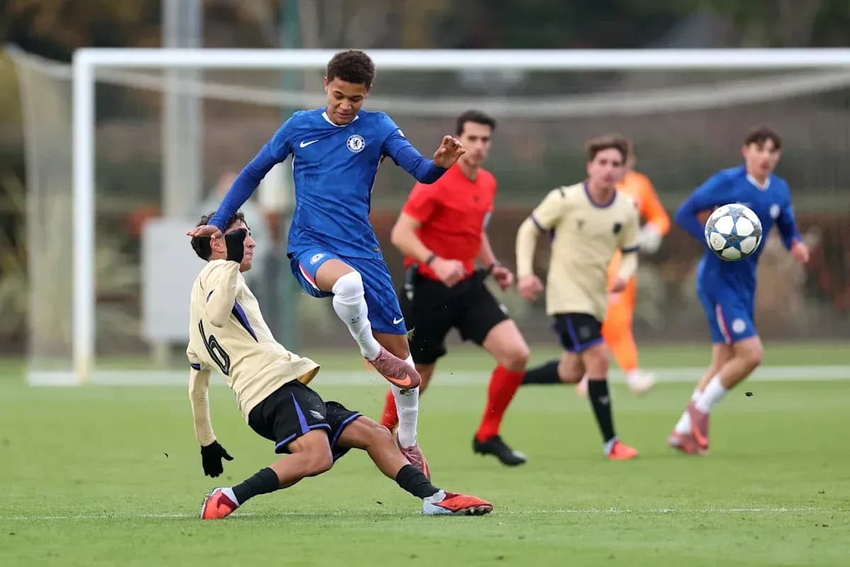 Player in blue jumping over opponent on field