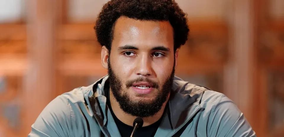 Athlete speaking at a press conference podium