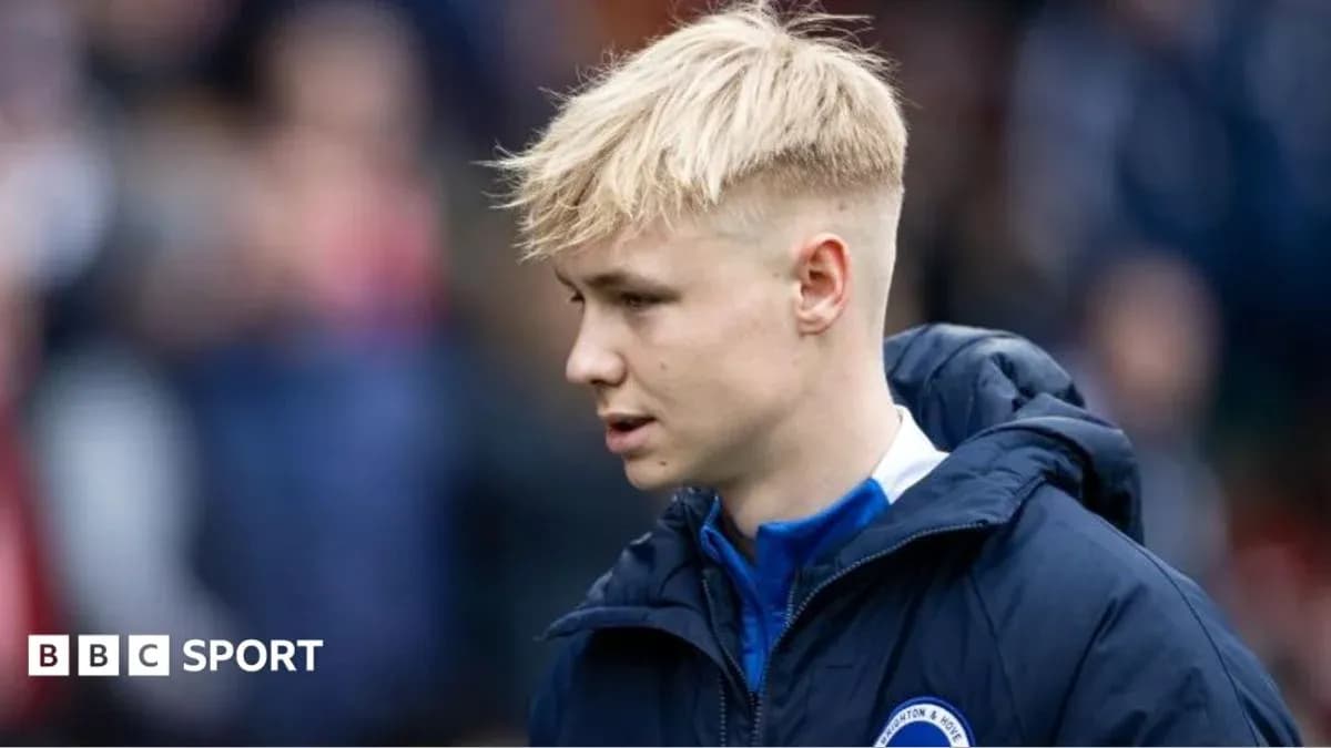 Player in team jacket walking on the sidelines