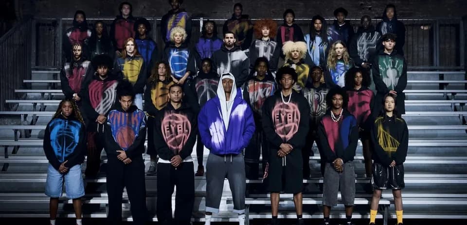 Group of young models in colorful hoodies posing