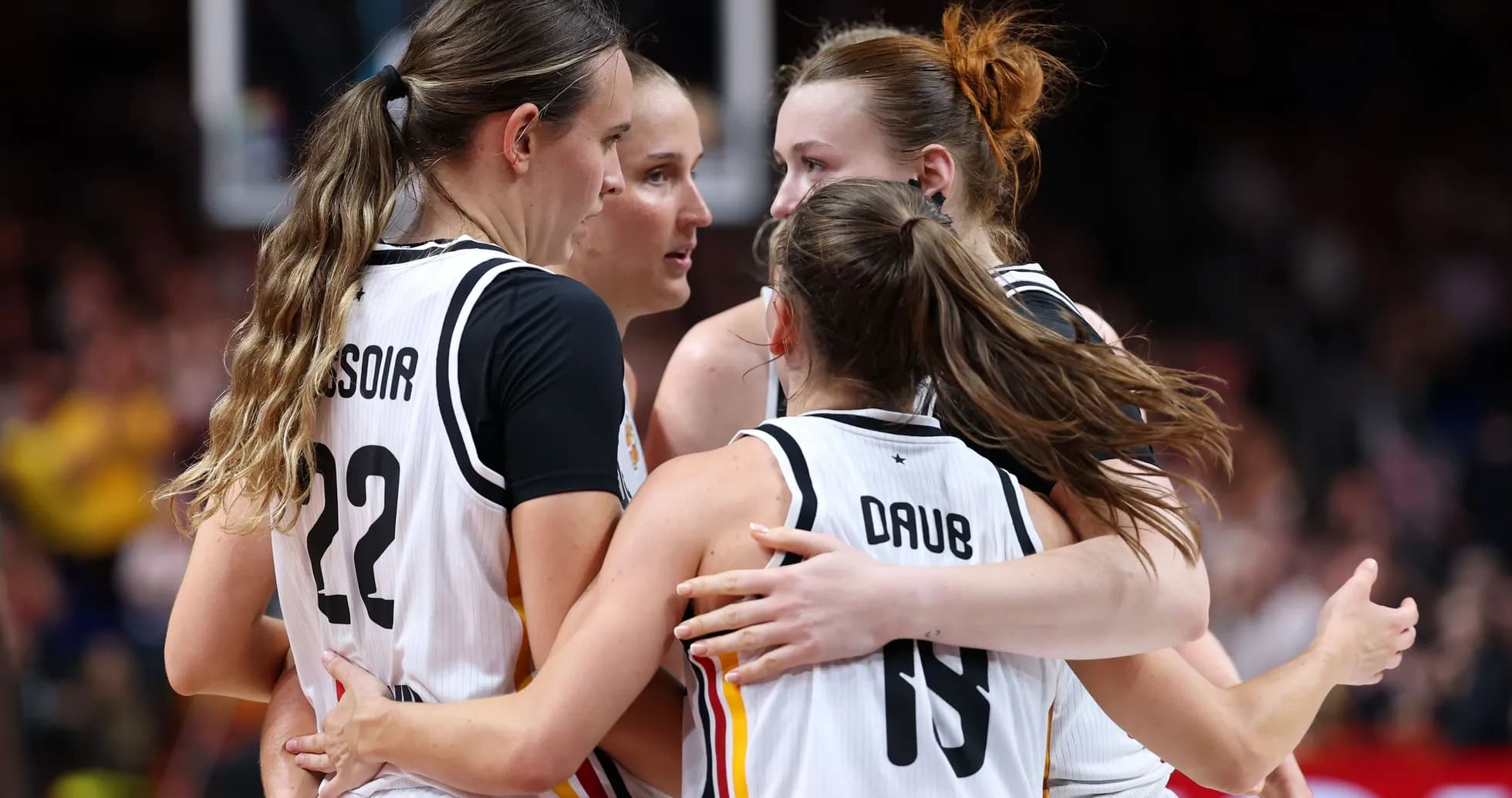 Four players celebrating during a basketball game