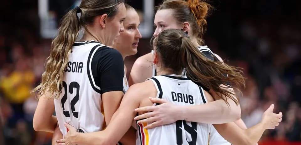 Four players celebrating during a basketball game