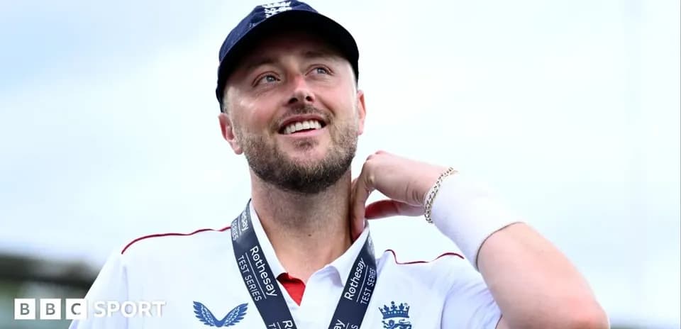 Cricketer wearing medal and smiling at event