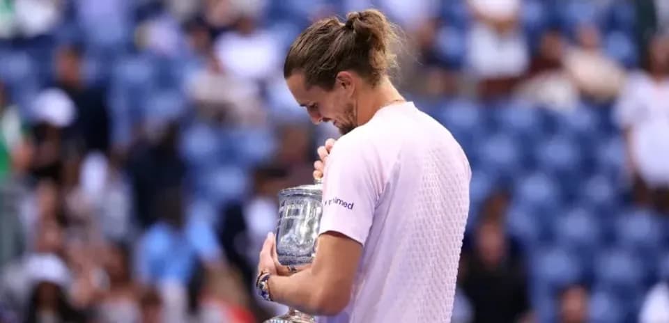 Player holding trophy after winning tennis match
