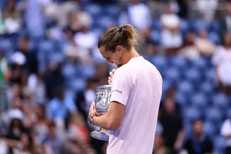 Player holding trophy after winning tennis match