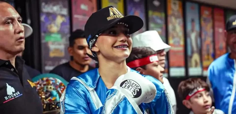 Boxer smiling in preparation with team members