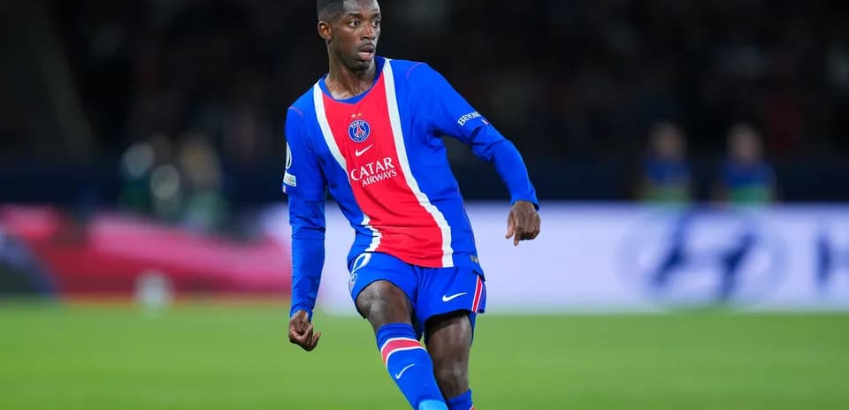 Player in PSG kit dribbling the ball on field