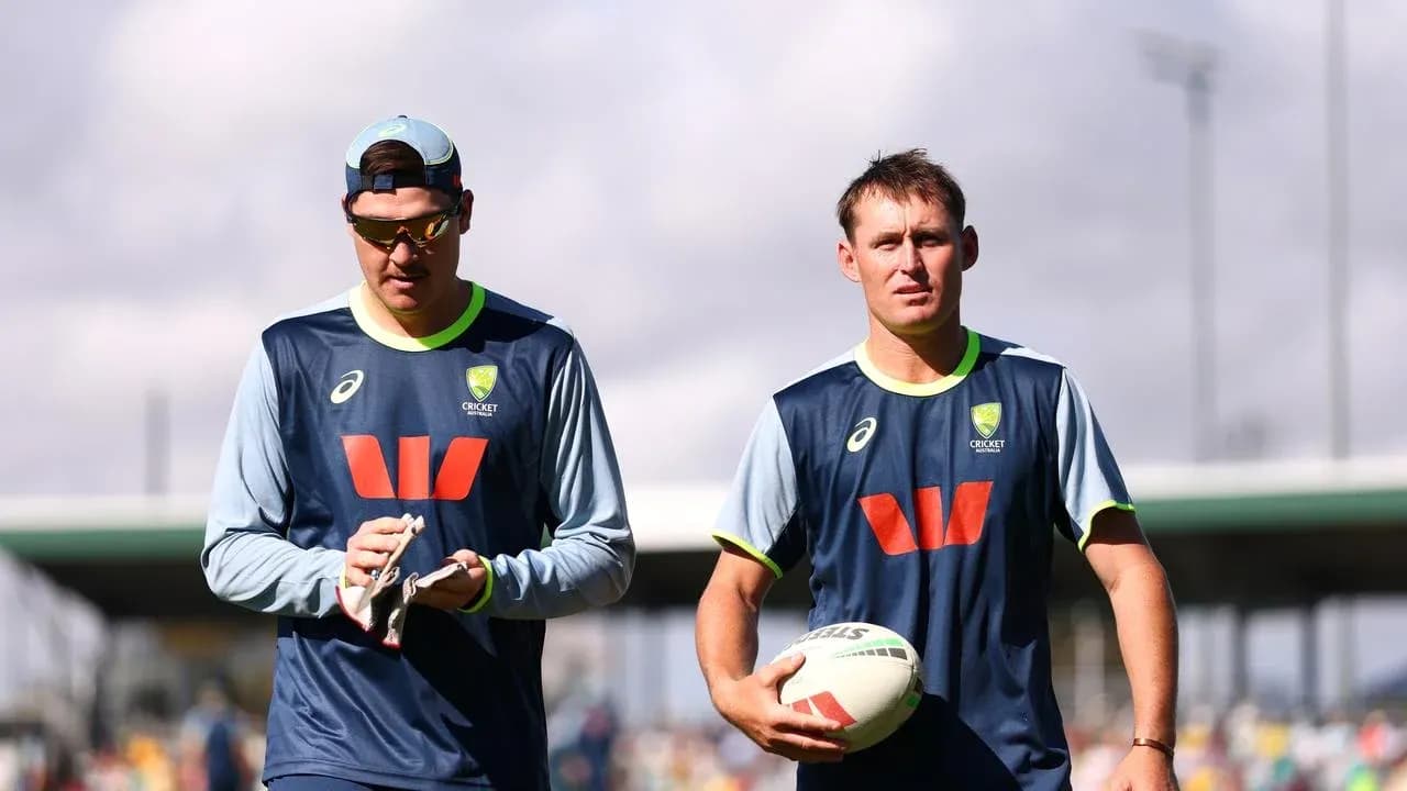 Two cricketers walking during training session