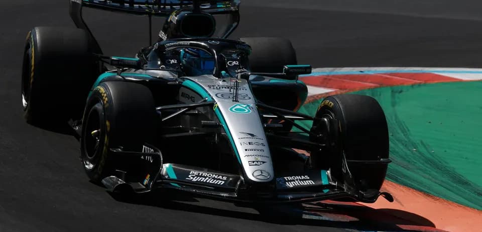 Mercedes F1 car navigating a corner on track