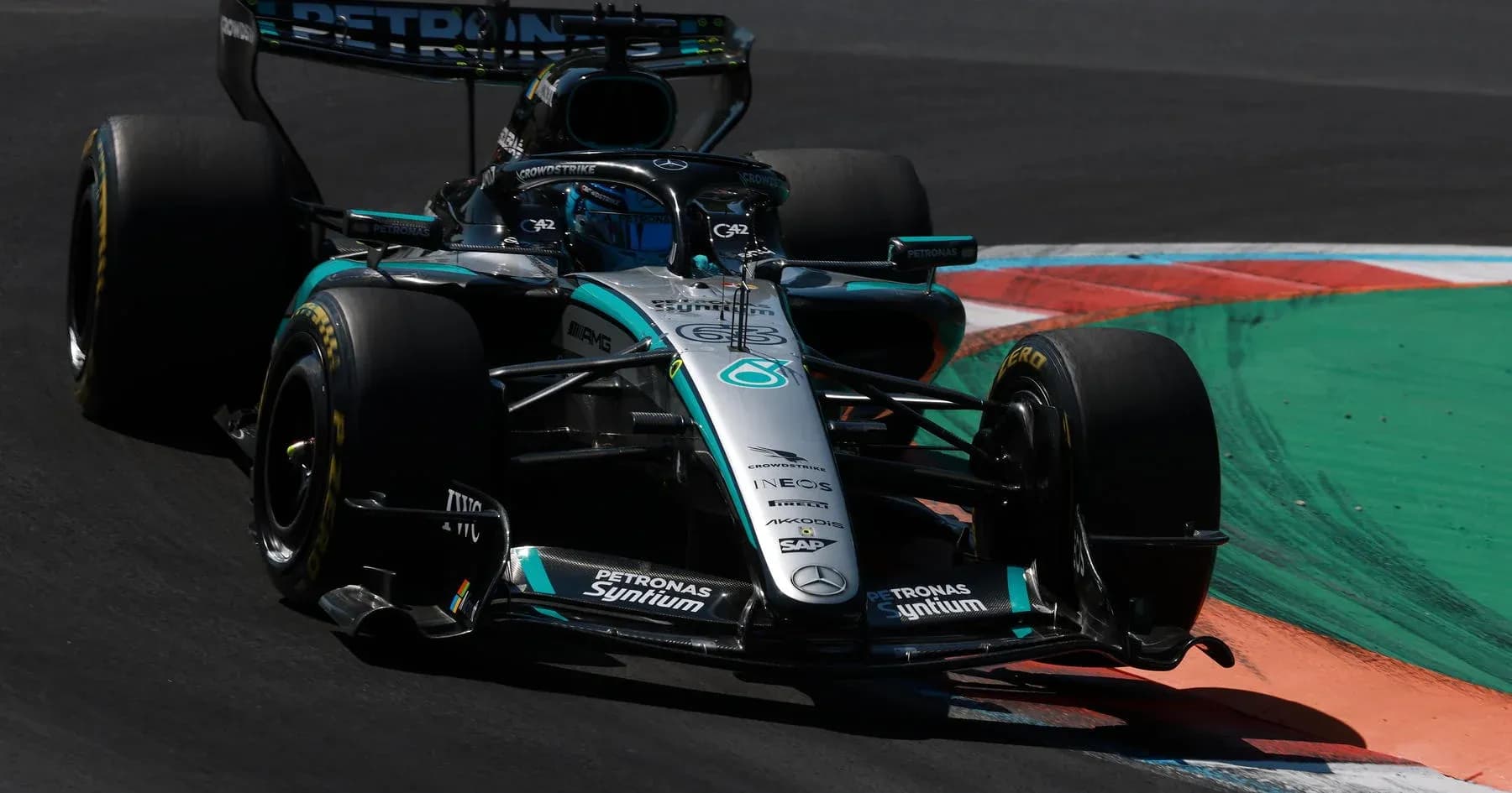 Mercedes F1 car navigating a corner on track