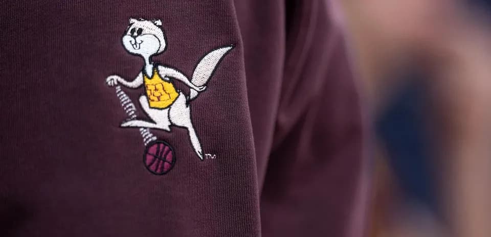 Embroidered mascot logo on a maroon sweatshirt