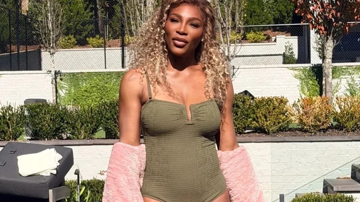 Person posing in a swimsuit with a pink cover-up