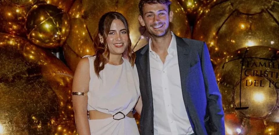 Man and woman posing at a festive event