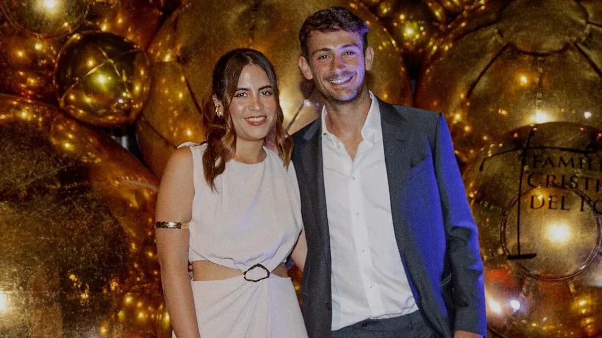 Man and woman posing at a festive event