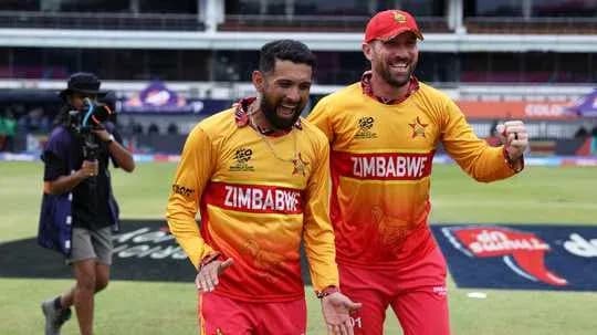 Two Zimbabwe cricket players celebrating on the field