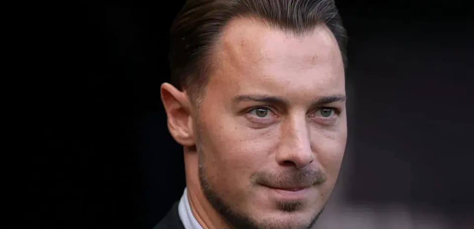 Close-up of a man in a suit with short hair