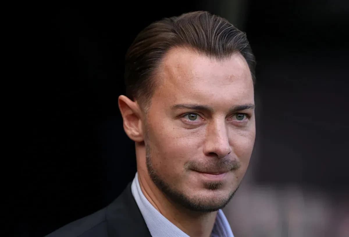 Close-up of a man in a suit with short hair