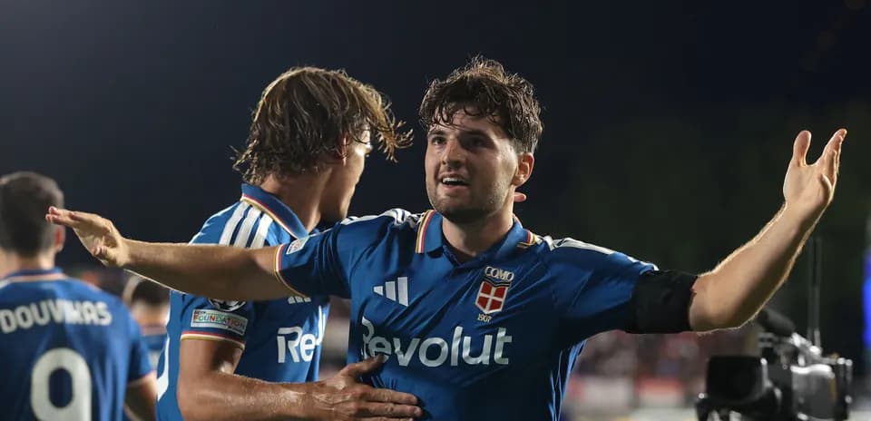 Player celebrating a goal with teammates on field