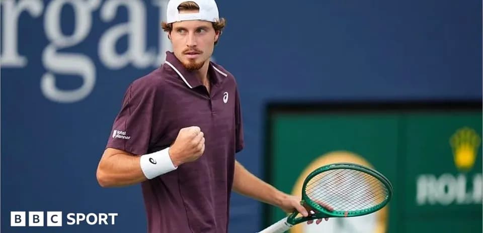 Tennis player celebrating a point with racket raised