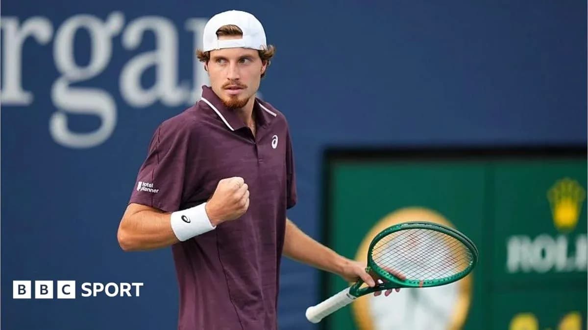 Tennis player celebrating a point with racket raised