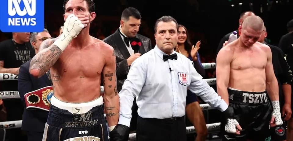 Boxers and referee in the ring after match