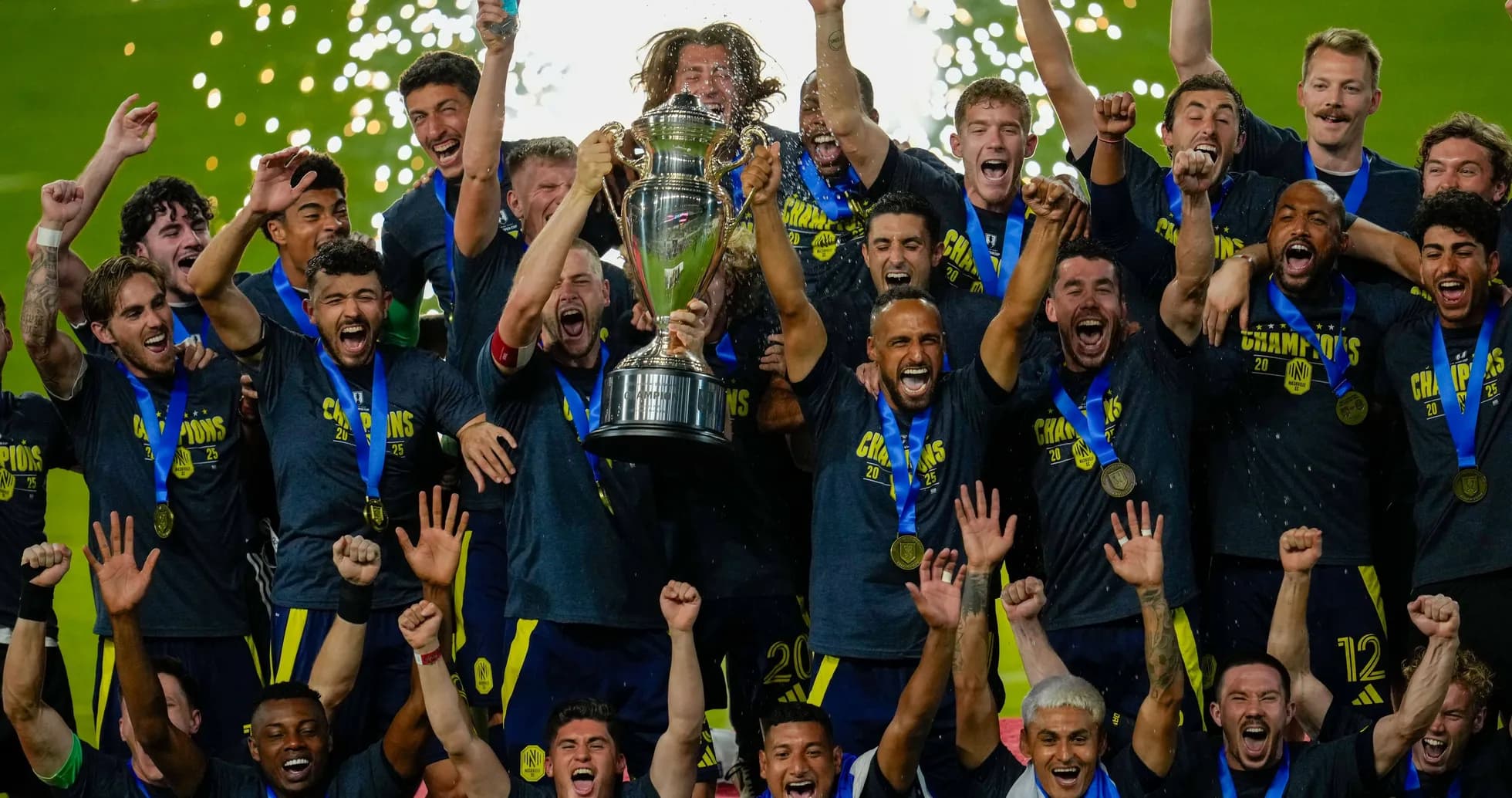 Team celebrating championship victory with trophy